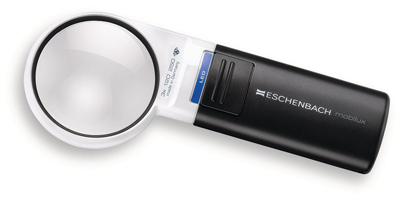 A handheld Eschenbach Mobilux magnifying glass with a white and black body, featuring a clear circular lens and a blue power button accent. Model 15112