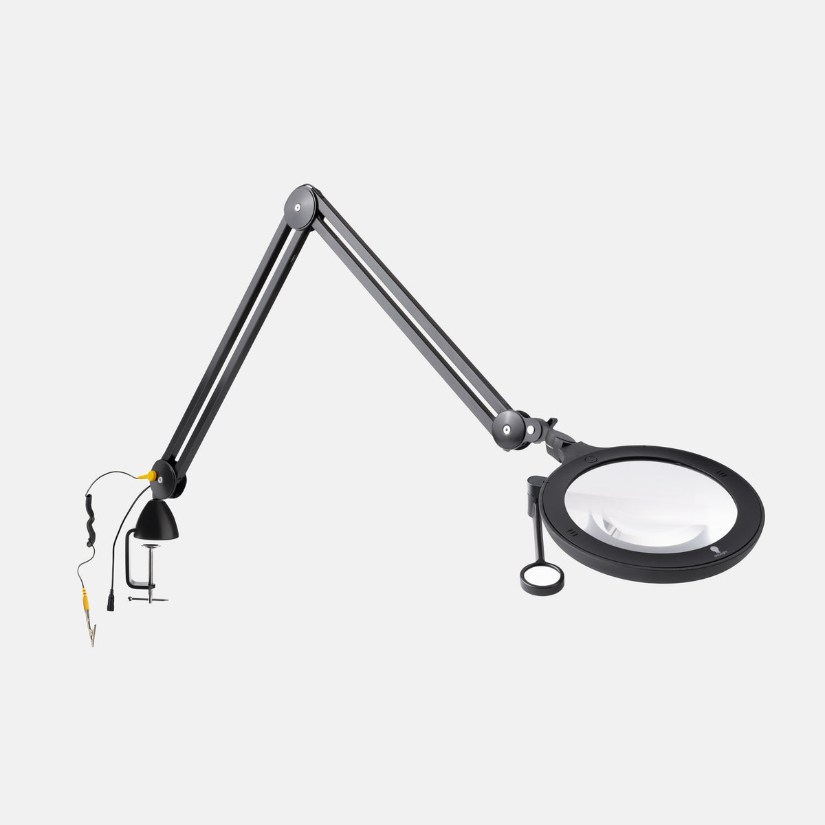 A black adjustable desktop magnifier lamp with a circular magnifying glass, hanging loop, and separate clamp lamp attachment on a light gray background.