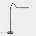 A modern black floor lamp with a curved neck and a horizontal arm, standing on a round base against a light gray background.