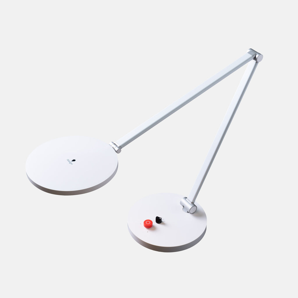 A modern white adjustable desk lamp with two circular lamp heads and a slim articulated arm, shown on a light gray background.