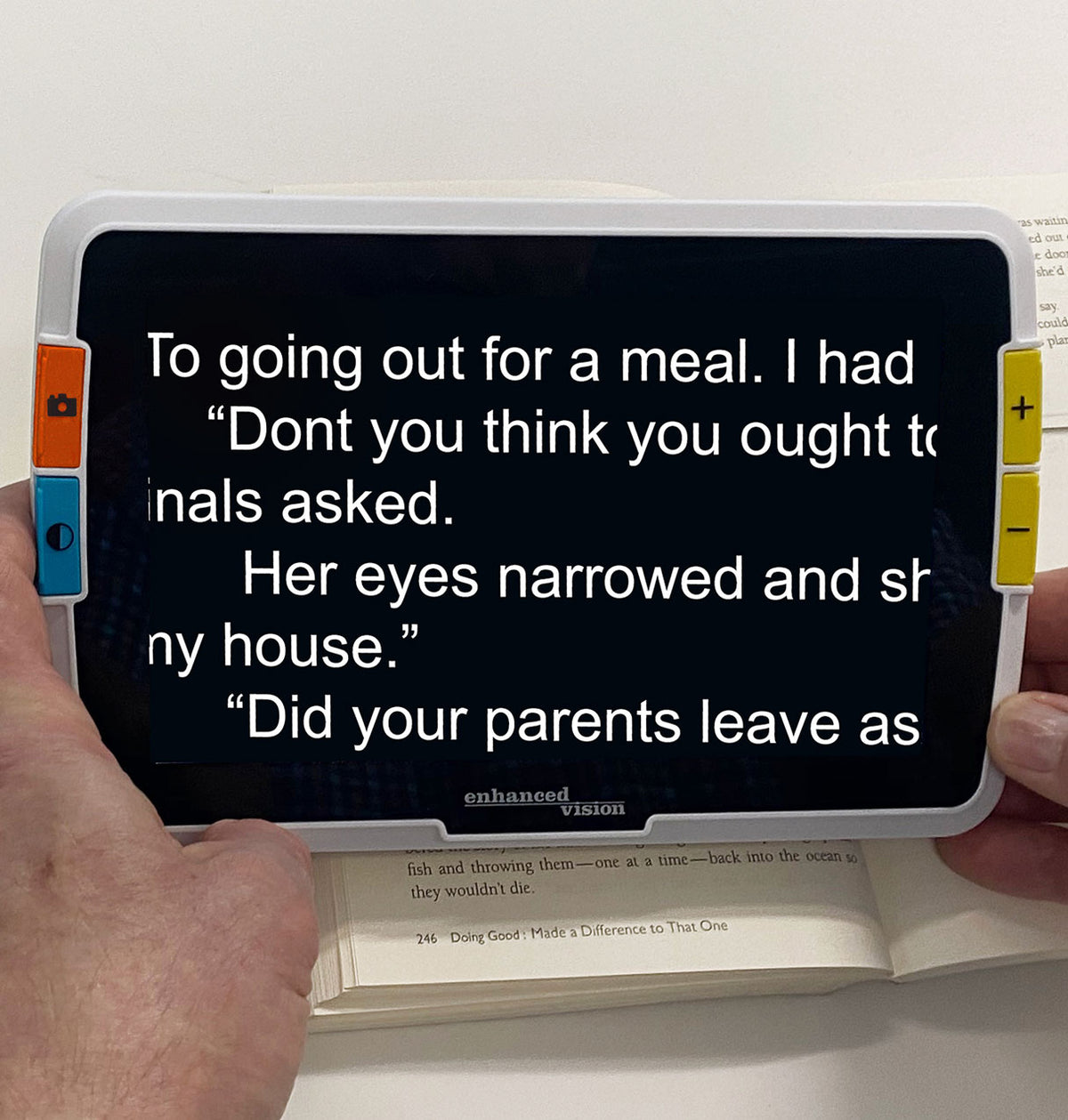 Amigo 8HD with Text on a screen held by a person with a white background