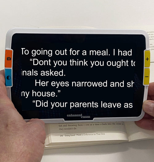 Amigo 8HD with Text on a screen held by a person with a white background
