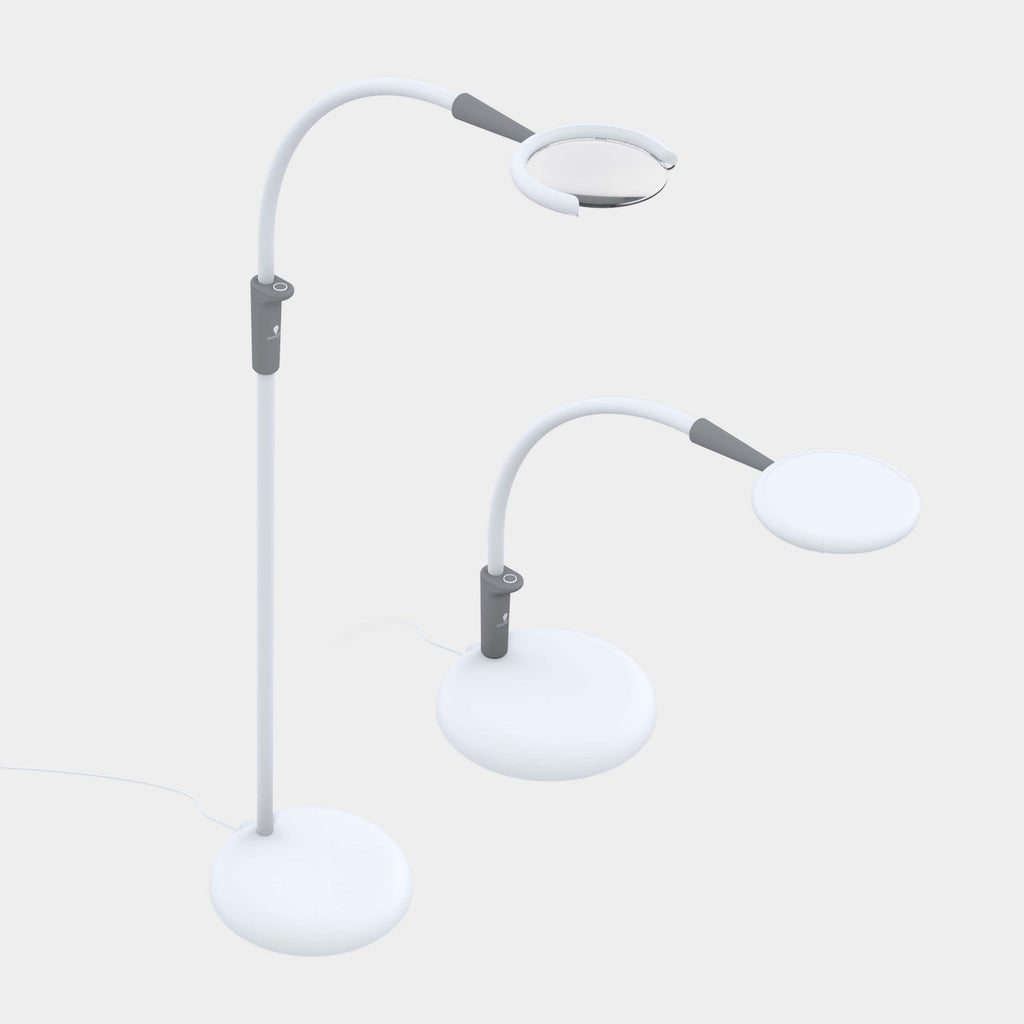 A modern white floor lamp with two adjustable arms and circular heads, shown on a plain light gray background. Light is shown extender arm up or down to vary lamp height. 