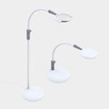 A modern white floor lamp with two adjustable arms and circular heads, shown on a plain light gray background. Light is shown extender arm up or down to vary lamp height. 