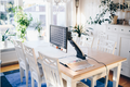 Dining room with a table and chairs, with Magnilink One 17" and plants around.