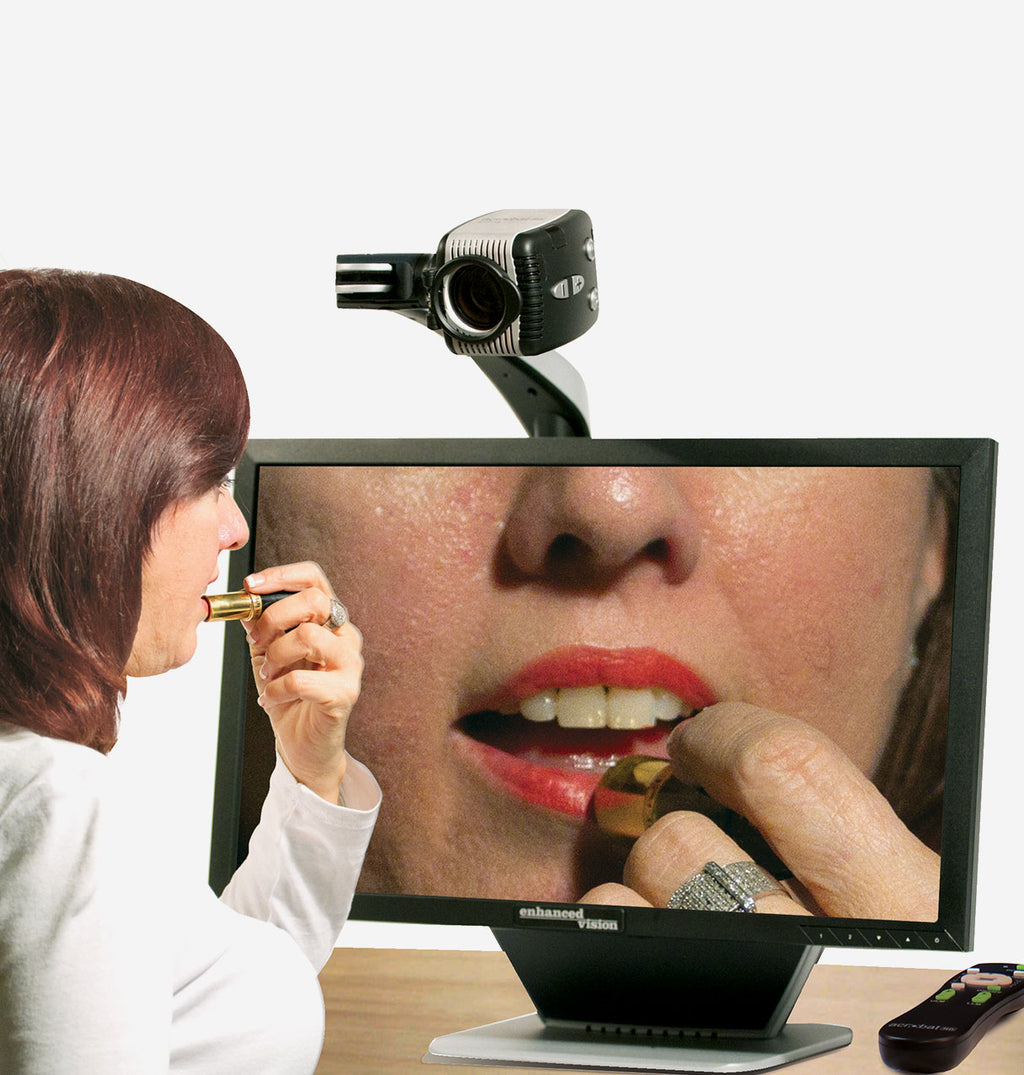 Woman using a Acrobat 27 HD Ultra to view a close-up of her own face on a monitor.