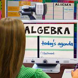 Person sitting in front of a computer screen with an 'Algebra' lesson displayed, usimg the DaVinci 