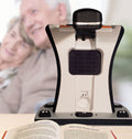 Smart Reader HD on a desk with a blurred background of two people smiling
