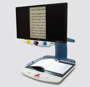 Topaz 24XL HD with screen displaying text on a white background with magazine below. This is a side view. 